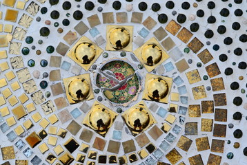 The background is made up of fragments of tiles.