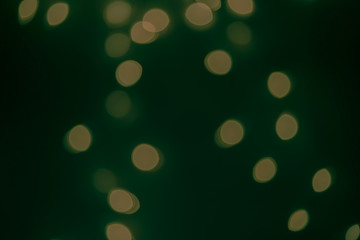 Dark Festive Christmas Beautiful abstract Background with bokeh lights. Holiday Texture with copy space. Can be used as Wallpaper, filling for a website, defocused