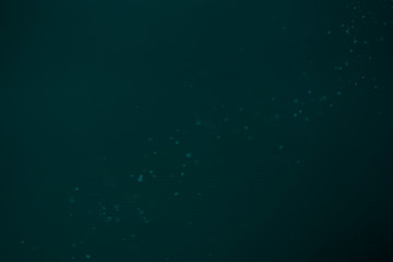 Dark Festive Christmas Beautiful abstract Background with bokeh lights. Holiday Texture with copy space. Can be used as Wallpaper, filling for a website, defocused