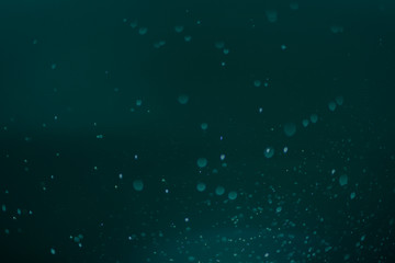 Dark Festive Christmas Beautiful abstract Background with bokeh lights. Holiday Texture with copy space. Can be used as Wallpaper, filling for a website, defocused