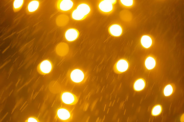 Yellow Gold Festive Christmas Beautiful abstract Background with bokeh lights. Holiday Texture with copy space. Can be used as Wallpaper, filling for a website, defocused