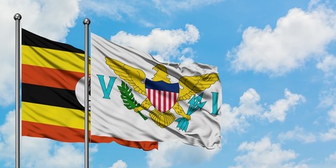 Uganda and United States Virgin Islands flag waving in the wind against white cloudy blue sky together. Diplomacy concept, international relations.