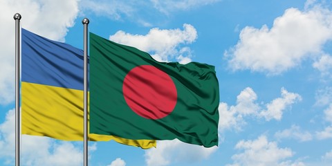 Ukraine and Bangladesh flag waving in the wind against white cloudy blue sky together. Diplomacy concept, international relations.