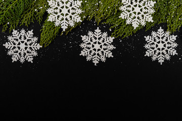 Christmas composition. Girlanda with drops and snow on black background. Christmas, winter, new year concept. Flat lay, top view, copy space. © Julio Ricco