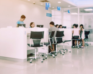 Blur image of people sit and waiting in financial transactions in the bank.