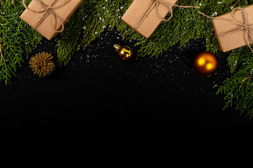 Christmas composition. Girlanda with Christmas ornaments and gifts on black background. Christmas, winter, new year concept. Flat lay, top view, copy space. © Julio Ricco