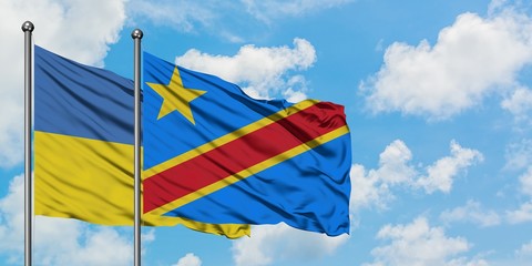 Ukraine and Congo flag waving in the wind against white cloudy blue sky together. Diplomacy concept, international relations.
