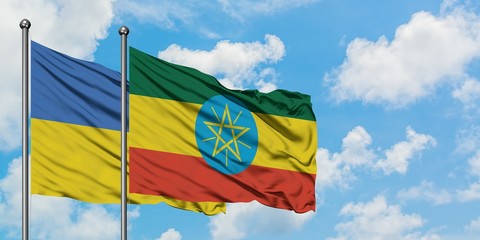 Ukraine and Ethiopia flag waving in the wind against white cloudy blue sky together. Diplomacy concept, international relations.