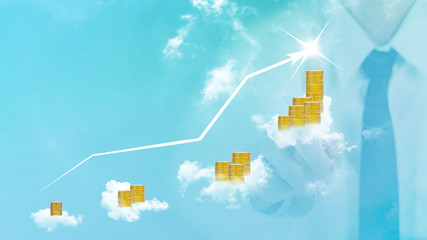 gold coins and cloud with blurred businessman plan business growth and chart of indicators and sky background
