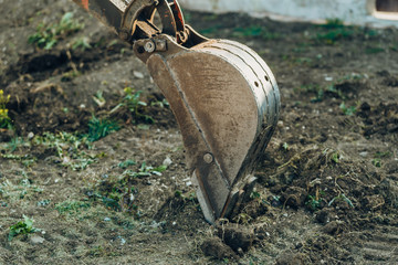 Large crawler excavator bucket. Excavator mechanical part for digging. Machines and mechanisms for construction.