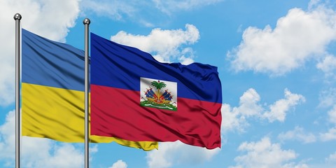 Ukraine and Haiti flag waving in the wind against white cloudy blue sky together. Diplomacy concept, international relations.