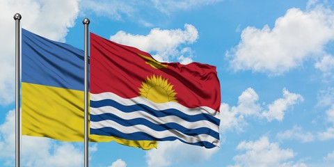 Ukraine and Kiribati flag waving in the wind against white cloudy blue sky together. Diplomacy concept, international relations.