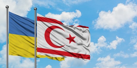 Ukraine and Northern Cyprus flag waving in the wind against white cloudy blue sky together. Diplomacy concept, international relations.