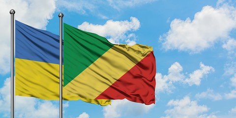 Ukraine and Republic Of The Congo flag waving in the wind against white cloudy blue sky together. Diplomacy concept, international relations.
