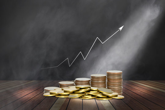 Coins Stack With Lighting And Smoke On Wooden Stage And Chart Of Indicators