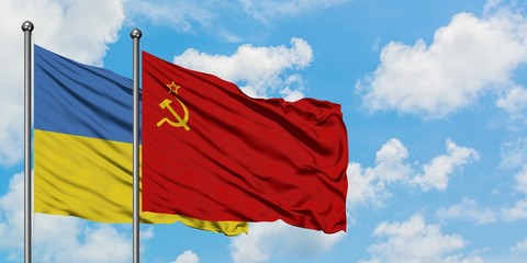 Ukraine and Soviet Union flag waving in the wind against white cloudy blue sky together. Diplomacy concept, international relations.