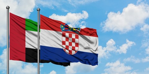 United Arab Emirates and Croatia flag waving in the wind against white cloudy blue sky together. Diplomacy concept, international relations.