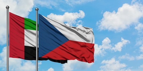 United Arab Emirates and Czech Republic flag waving in the wind against white cloudy blue sky together. Diplomacy concept, international relations.