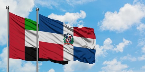 United Arab Emirates and Dominican Republic flag waving in the wind against white cloudy blue sky together. Diplomacy concept, international relations.