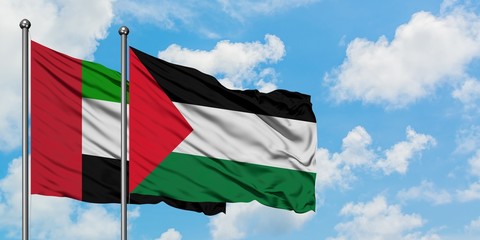 United Arab Emirates and Palestine flag waving in the wind against white cloudy blue sky together. Diplomacy concept, international relations.