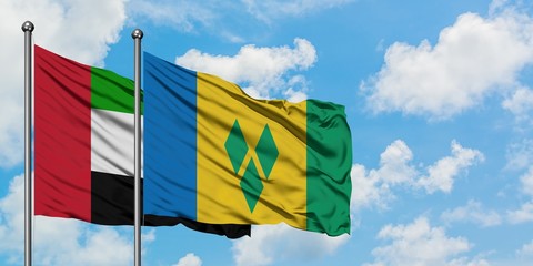 United Arab Emirates and Saint Vincent And The Grenadines flag waving in the wind against white...