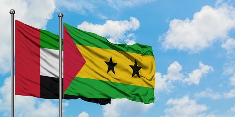United Arab Emirates and Sao Tome And Principe flag waving in the wind against white cloudy blue sky together. Diplomacy concept, international relations.