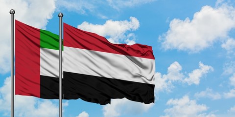 United Arab Emirates and Yemen flag waving in the wind against white cloudy blue sky together. Diplomacy concept, international relations.