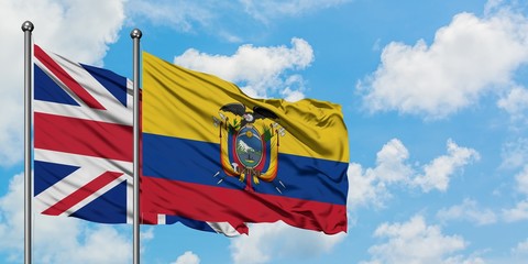 United Kingdom and Ecuador flag waving in the wind against white cloudy blue sky together. Diplomacy concept, international relations.