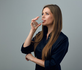 woman in black dress drinking water.