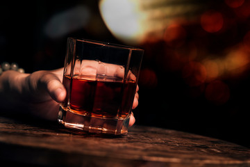 whisky shot glass at bar counter.