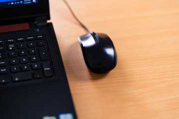 Obraz na płótnie Canvas Black wired computer mouse closeup toned.