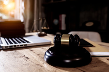 justice and law concept. lawyers discussing contract papers with brass scale on wooden desk in office.	