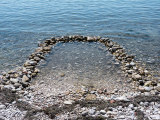 Handmade stone pool for kids with eater on seaside