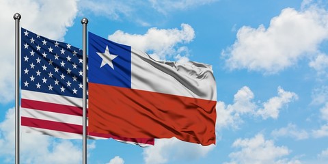 United States and Chile flag waving in the wind against white cloudy blue sky together. Diplomacy concept, international relations.