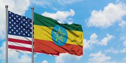 United States and Ethiopia flag waving in the wind against white cloudy blue sky together. Diplomacy concept, international relations.