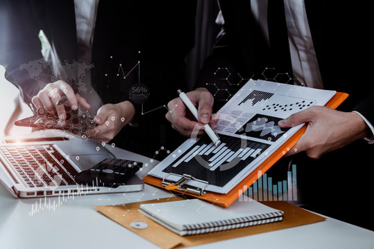 Business teamwork or business partners discussing documents and meeting at the office desk. Global Strategy Virtual Icon.Innovation Graphs Interfaces. Workplace strategy concept.