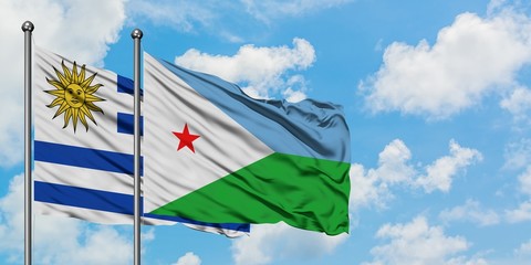 Uruguay and Djibouti flag waving in the wind against white cloudy blue sky together. Diplomacy concept, international relations.