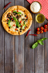 Traditional italian food: pizza on dark wooden background top view copy space