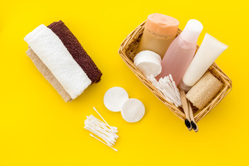 Obraz na płótnie Canvas Bathroom cosmetics and hygiene products on yellow background top view