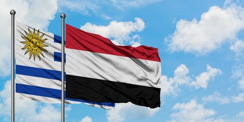 Uruguay and Yemen flag waving in the wind against white cloudy blue sky together. Diplomacy concept, international relations.