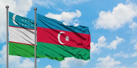 Uzbekistan and Azerbaijan flag waving in the wind against white cloudy blue sky together. Diplomacy concept, international relations.