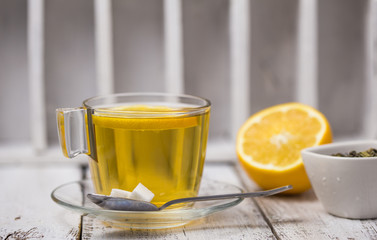 Tea in a glass cup mint leaves dried tea sliced lime. herbs tea