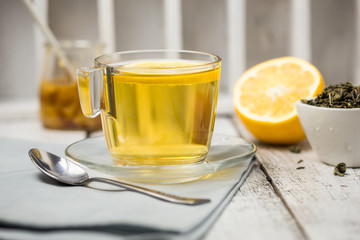 Tea in a glass cup mint leaves dried tea sliced lime. herbs tea