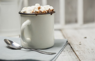 Christmas cocoa header with marshmallows, chocolate crumbs, and syrup. Large coffee cup with homemade hot chocolate