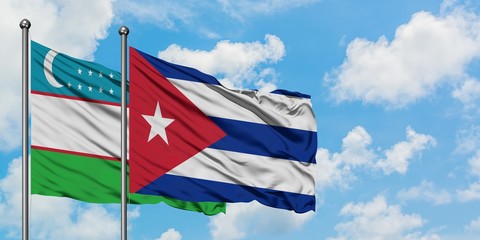 Uzbekistan and Cuba flag waving in the wind against white cloudy blue sky together. Diplomacy concept, international relations.