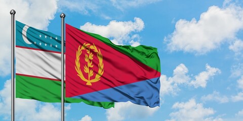 Uzbekistan and Eritrea flag waving in the wind against white cloudy blue sky together. Diplomacy concept, international relations.