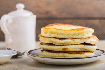 Tasty breakfast. Homemade pancakes with crushed berry, honey or maple syrup on white grey  background.