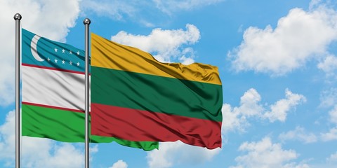 Uzbekistan and Lithuania flag waving in the wind against white cloudy blue sky together. Diplomacy concept, international relations.