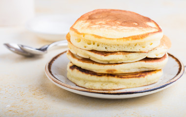 Tasty breakfast. Homemade pancakes with crushed berry, honey or maple syrup on white grey  background.