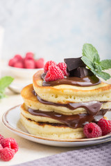 Tasty breakfast. Homemade pancakes with crushed berry, honey or maple syrup on white grey  background.
